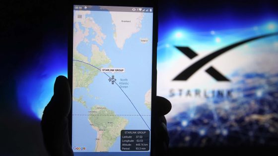 A satellite tracker image is seen displayed on a smartphone with a Starlink logo in the background — Image credit: TechRadar / https://www.techradar.com/author/alex-blake