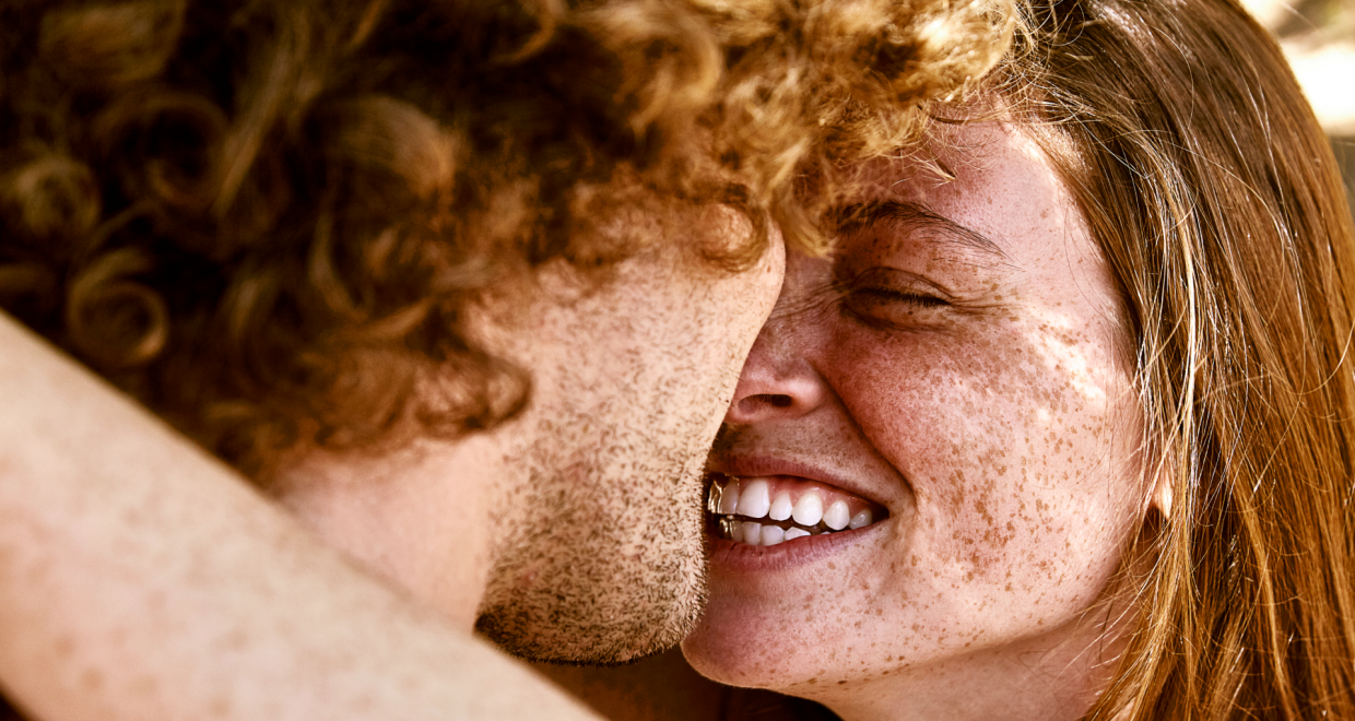 two redheaded people - a man and a woman - hugging and looking at one another — Image credit: 'Human evolution didn't slow down; we were just missing the signal': Large DNA study reveals natural selection led to more redheads and less male-pattern baldness / https://www.livescience.com/author/kristina-killgrove